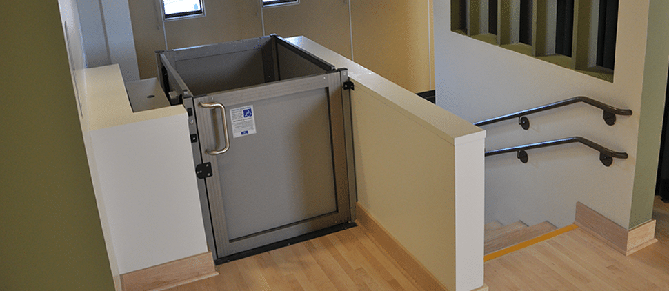 wheelchair lift installed in school next to stairs